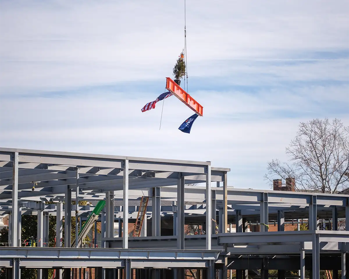 The topping out beam while it is being flown into place