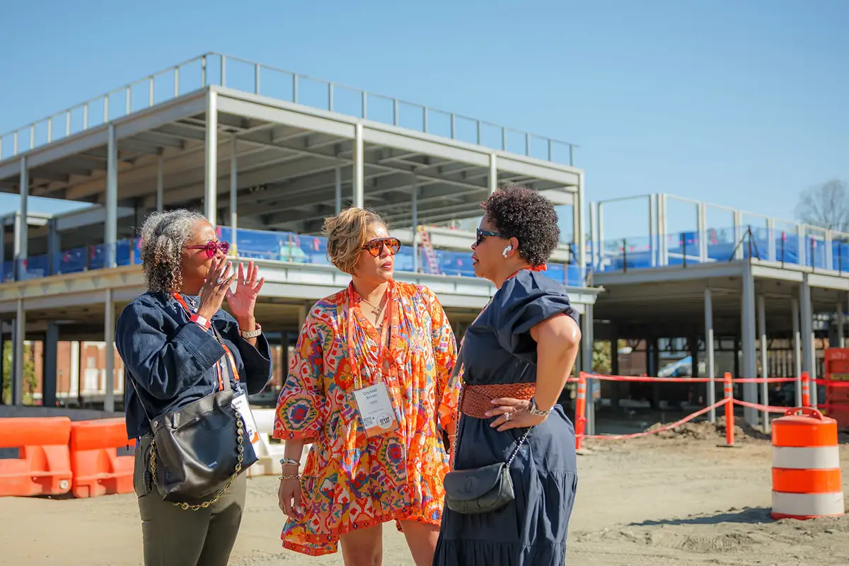Alumni at the construction site of Aggarwal Hall