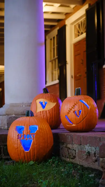 Phone background: UVA-themed jack-o-lanterns on the Lawn